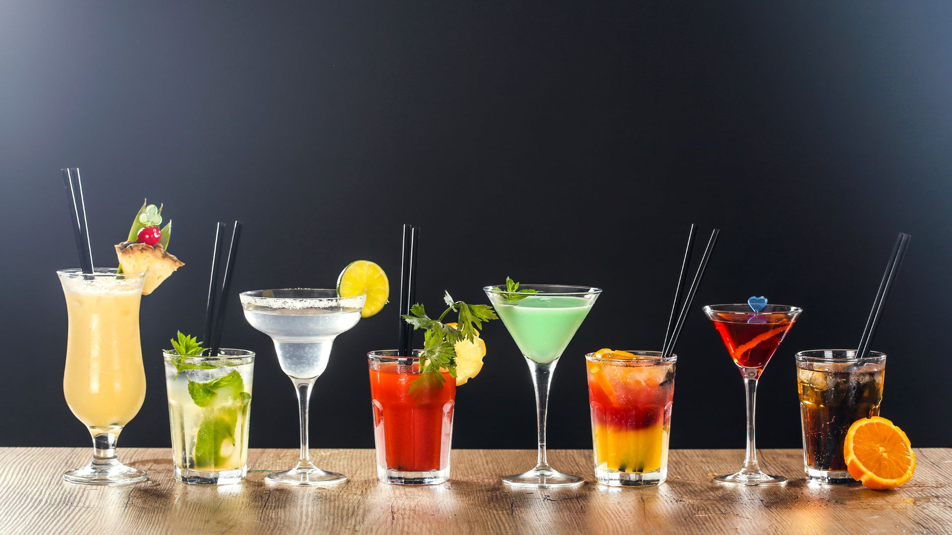 A variety of cocktails lined up on a table