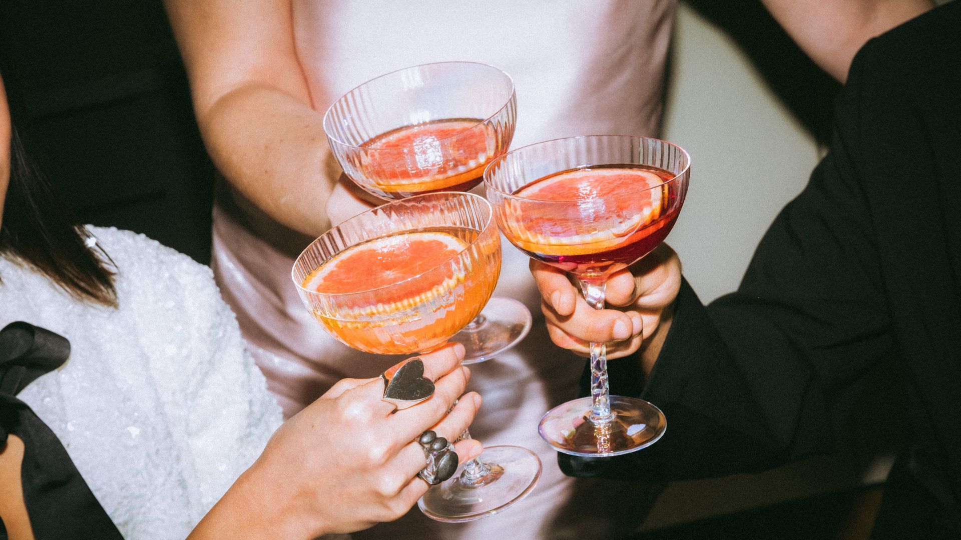 A group of people holding up wine glasses