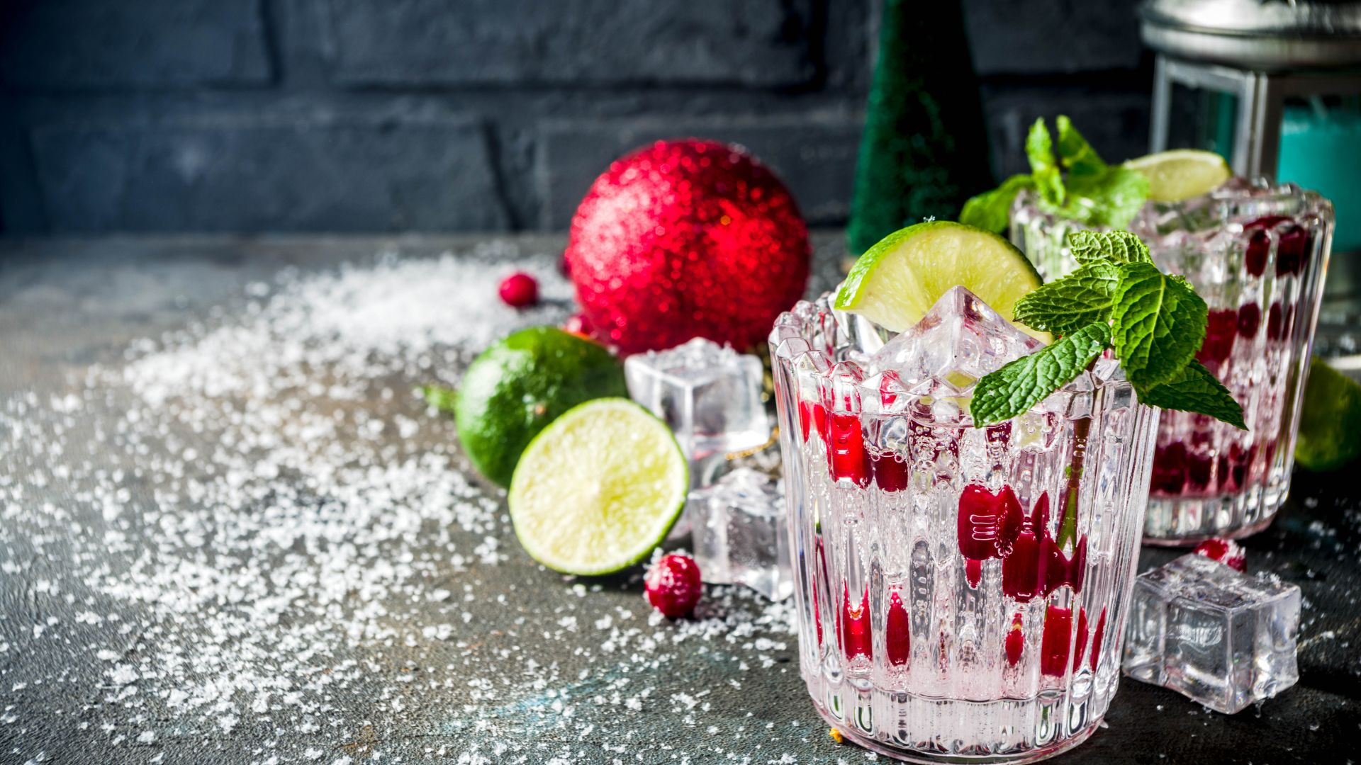 Three glasses filled with ice and limes on a table