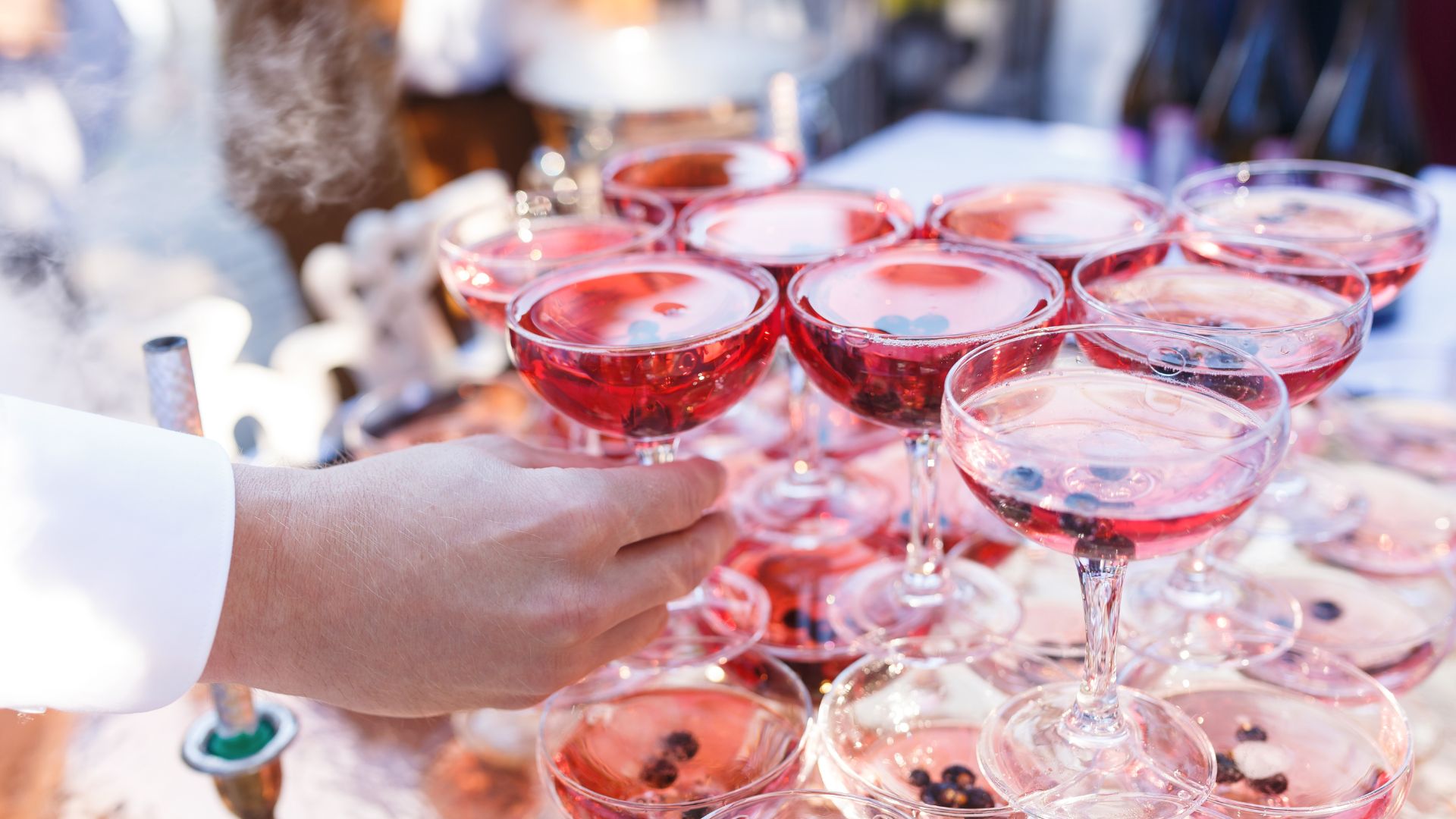 A table topped with lots of glasses of wine